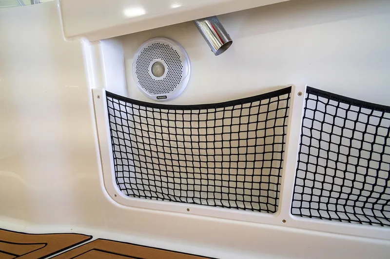  Yacht Photos Pics Jeanneau Leader 9.0 CC 2020 boat interior with speaker and storage netting.