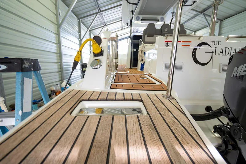  Yacht Photos Pics 2020 Jeanneau Leader 9.0 CC boat interior with teak decking in a metal shed.