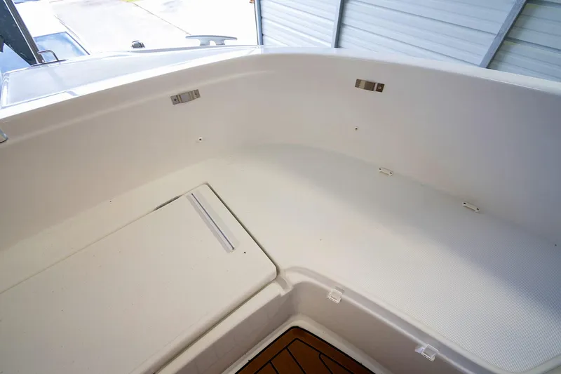  Yacht Photos Pics 2020 Jeanneau Leader 9.0 CC boat interior with white seating and storage compartment.