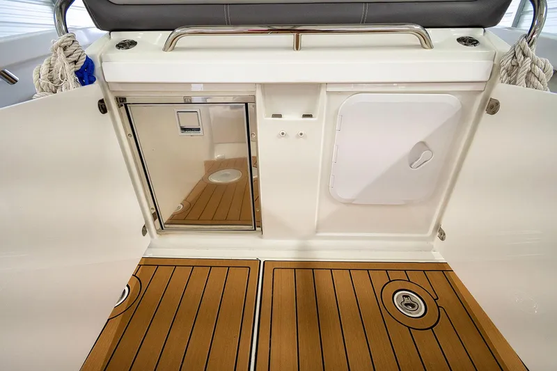  Yacht Photos Pics 2020 Jeanneau Leader 9.0 CC boat interior with teak flooring and storage compartments.