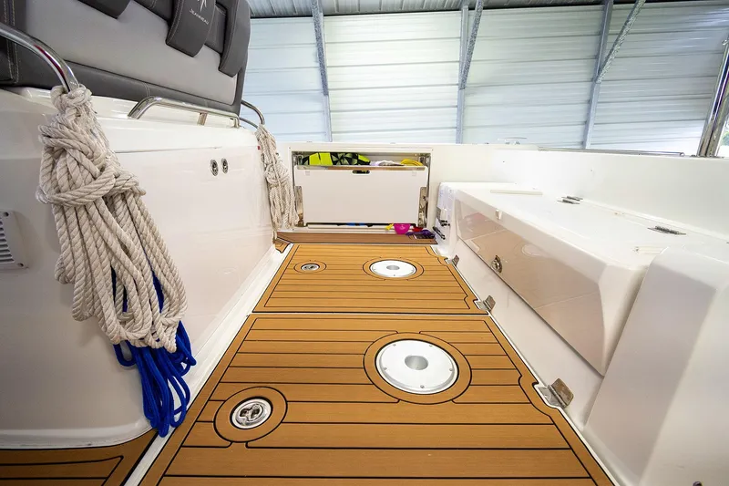  Yacht Photos Pics 2020 Jeanneau Leader 9.0 CC boat deck with teak flooring and storage compartments.