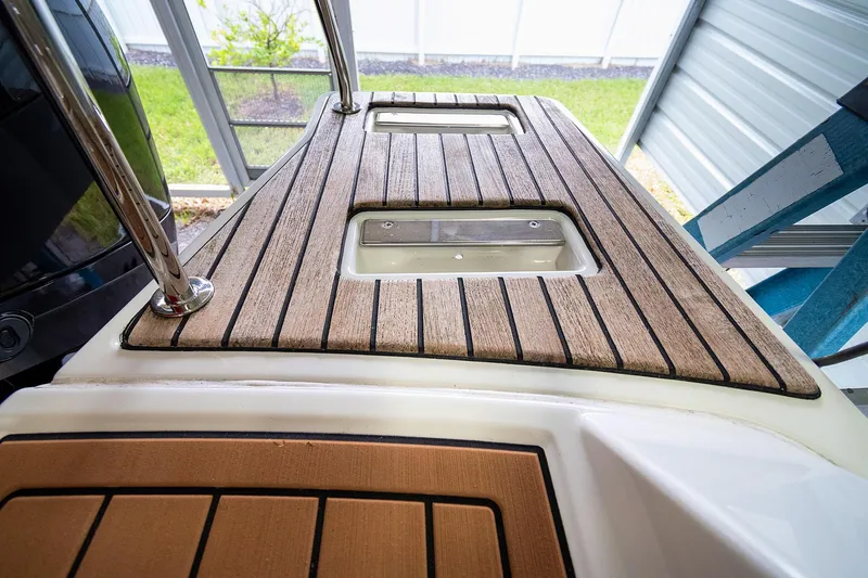  Yacht Photos Pics 2020 Jeanneau Leader 9.0 CC boat deck with wood finish, under shelter.