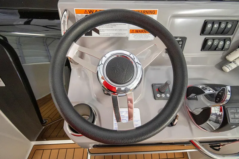  Yacht Photos Pics Steering wheel of 2020 Jeanneau Leader 9.0 CC boat with control panel.