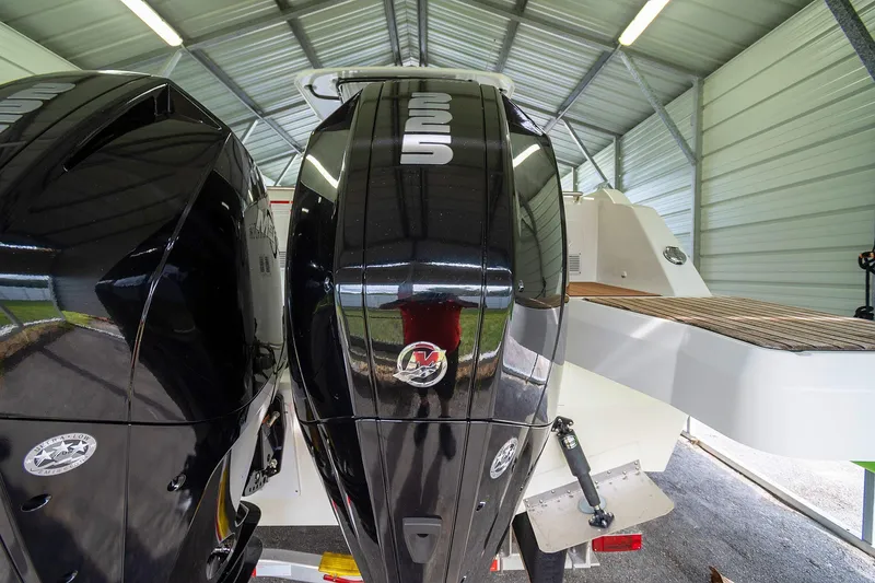  Yacht Photos Pics 2020 Jeanneau Leader 9.0 CC with dual outboard engines in a covered storage.