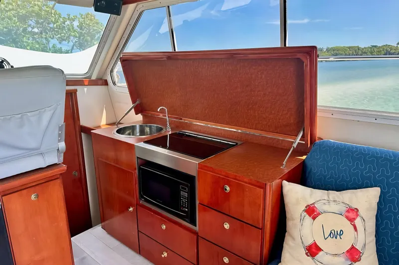  Yacht Photos Pics Interior of 2001 Zeta 32 Power Cat with kitchenette and scenic window view.