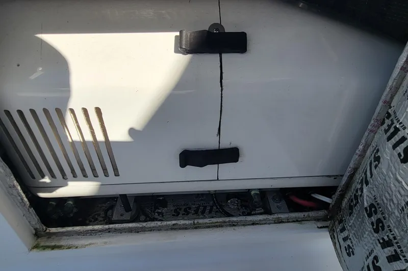  Yacht Photos Pics Cracked panel on 2001 Zeta 32 Power Cat boat, showing battery compartment.