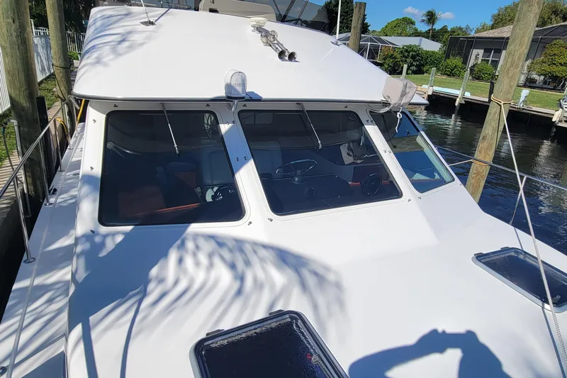  Yacht Photos Pics 2001 Zeta 32 Power Catamaran docked, showcasing sleek design and spacious deck.