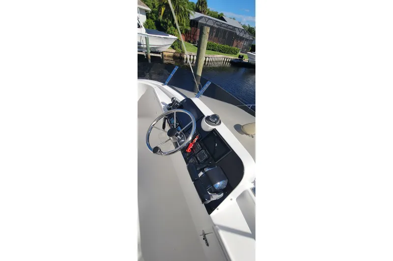  Yacht Photos Pics Helm of 2001 Zeta 32 Power Cat boat with steering wheel and controls.