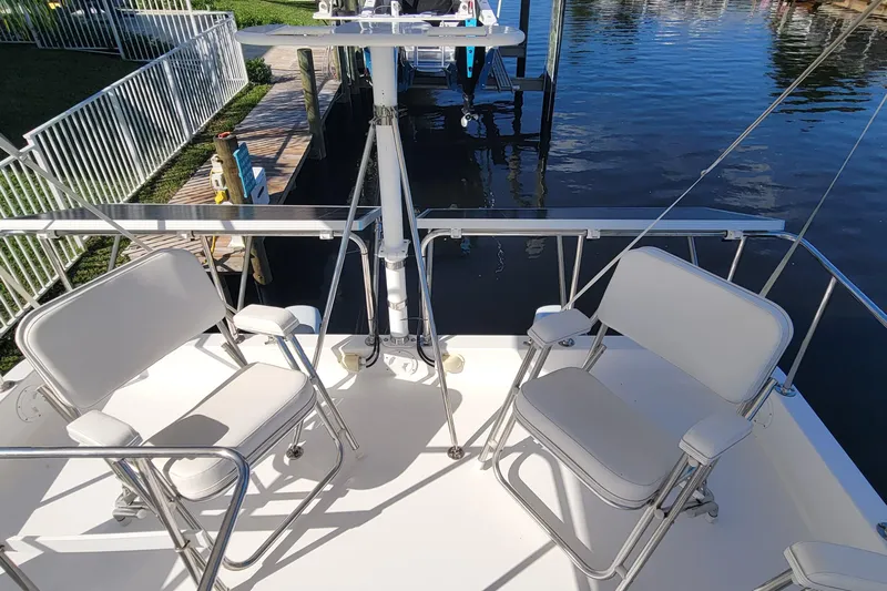  Yacht Photos Pics 2001 Zeta 32 Power Cat boat deck with white seating and railing by the water.