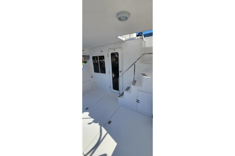  Yacht Photos Pics 2001 Zeta 32 Power Cat interior with stairs and door, featuring sleek white design.