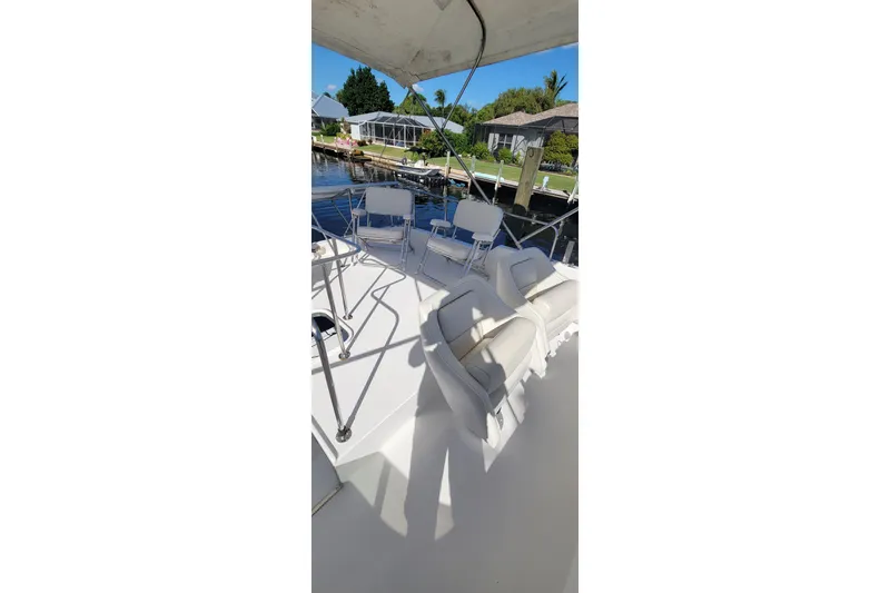  Yacht Photos Pics 2001 Zeta 32 Power Cat boat interior with white seating and waterfront view.