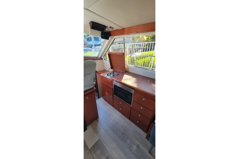  Yacht Photos Pics Interior of 2001 Zeta 32 Power Cat with kitchenette, featuring sink and microwave.