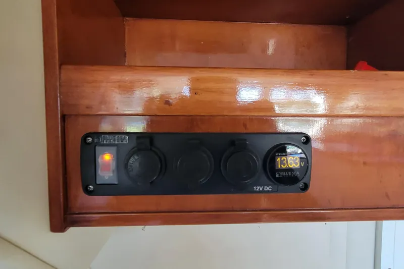  Yacht Photos Pics Control panel on 2001 Zeta 32 Power Cat displaying 13.63 volts, mounted on wooden surface.