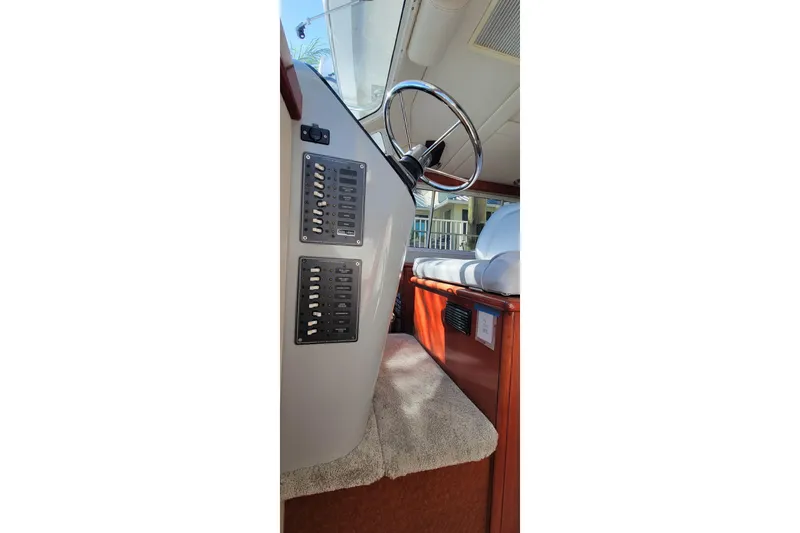  Yacht Photos Pics Interior view of 2001 Zeta 32 Power Cat boat showing steering wheel and control panel.