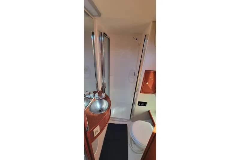  Yacht Photos Pics Bathroom interior of 2001 Zeta 32 Power Cat with sink, toilet, and shower.