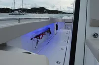 Aquila Molokai 28 boat interior with blue LED lighting, docked in a scenic harbor, 2022 model.