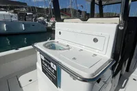 Aquila Molokai 28 boat, 2022 model, for sale at marina with yachts in background.
