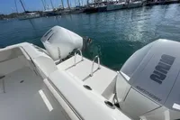Aquila Molokai 28 boat with dual Mercury engines docked in a marina, 2022 model.