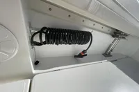 Coiled hose and storage compartment on 2022 Aquila Molokai 28 boat.