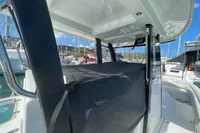 Aquila Molokai 28 (2022) boat interior with covered seating, docked at marina.