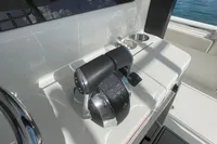 Control panel of 2022 Aquila Molokai 28 boat, featuring throttle and cup holder.