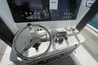 Steering console of 2022 Aquila Molokai 28 boat with controls and display.