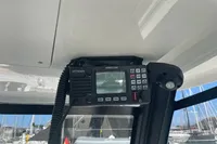 Radio equipment inside a 2022 Aquila Molokai 28 boat, with marina background.