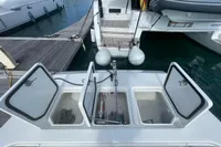 Aquila Molokai 28 (2022) boat with open storage compartments at the dock.
