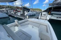Aquila Molokai 28, 2022 model, docked in a marina with other boats.