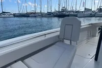 Aquila Molokai 28 boat interior, 2022 model, docked in a marina with sailboats.