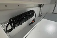 2022 Aquila Molokai 28 boat interior with coiled hose and seating area.