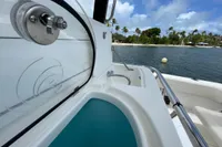 Aquila Molokai 28 boat interior, 2022 model, with ocean view and palm trees.