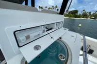 Aquila Molokai 28 boat storage compartment, 2022 model, near tropical shoreline.