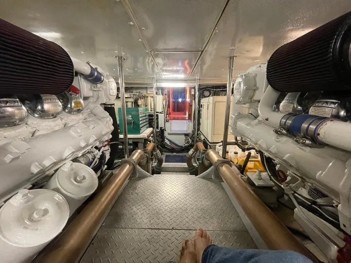 Southerly Yacht Photos Pics Engine room of a 1990 Lyman-Morse 52 yacht, featuring dual engines and metallic flooring.