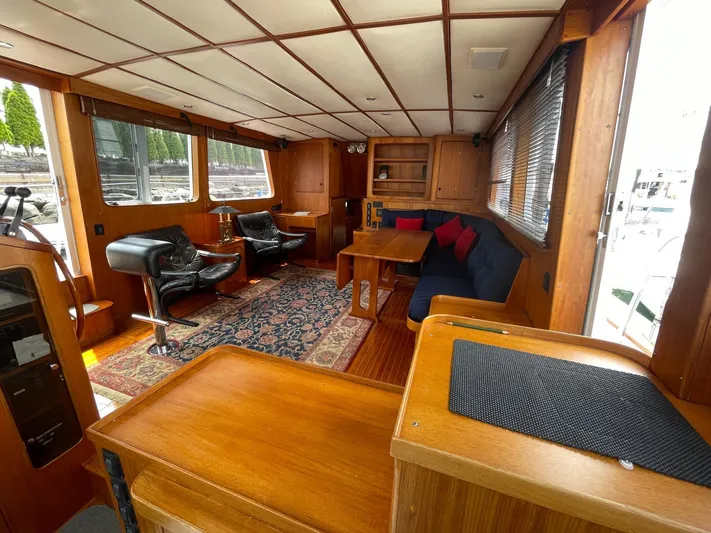 Southerly Yacht Photos Pics Luxurious interior of 1990 Lyman-Morse 52 yacht with wood finish and comfortable seating.