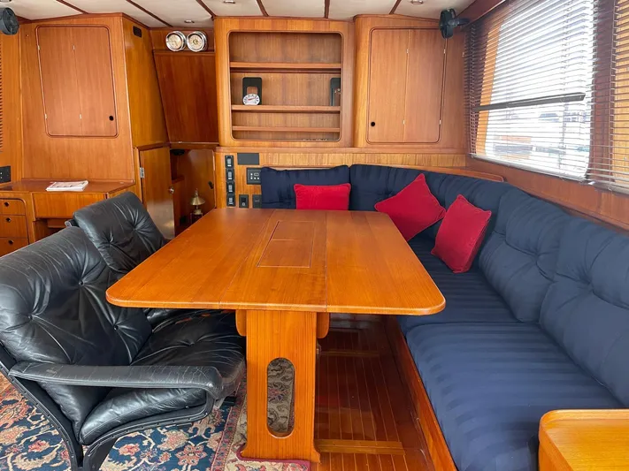 Southerly Yacht Photos Pics Luxurious 1990 Lyman-Morse 52 yacht interior with wooden dining area and plush seating.
