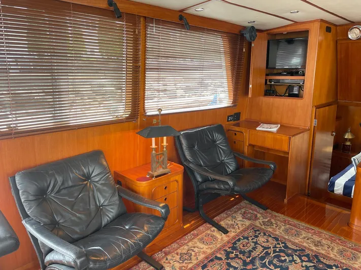 Southerly Yacht Photos Pics Luxurious interior of 1990 Lyman-Morse 52 yacht with leather chairs and wooden decor.