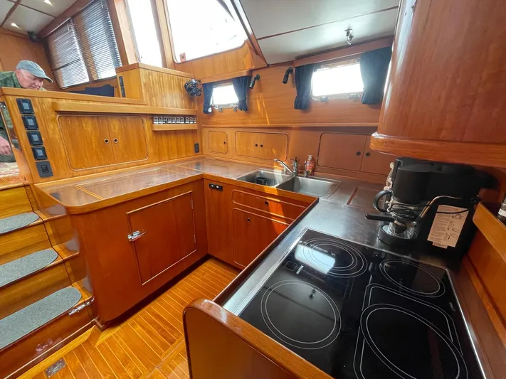 Southerly Yacht Photos Pics Luxurious wooden interior of a 1990 Lyman-Morse 52 yacht kitchen with modern appliances.