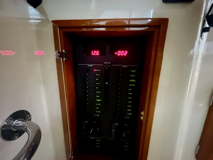 Yacht Photos Pics Electrical panel inside a 2005 Hinckley Picnic Boat EP, displaying voltage and current readings.