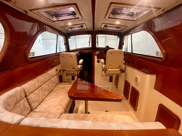  Yacht Photos Pics 2005 Hinckley Picnic Boat EP interior with wood accents and cushioned seating.