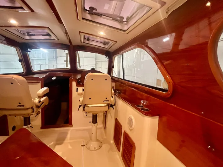  Yacht Photos Pics Interior of 2005 Hinckley Picnic Boat EP with wooden accents and seating.