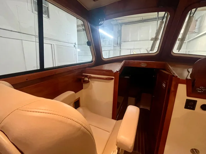  Yacht Photos Pics Interior of 2005 Hinckley Picnic Boat EP, featuring elegant wood and leather seating.