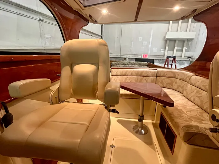  Yacht Photos Pics 2005 Hinckley Picnic Boat EP interior with beige seating and wooden table.