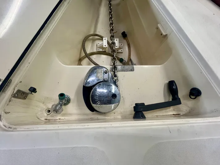  Yacht Photos Pics Anchor chain compartment of 2005 Hinckley Picnic Boat EP, featuring winch and handle.
