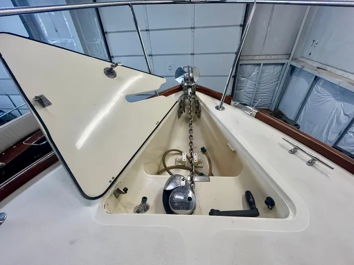  Yacht Photos Pics 2005 Hinckley Picnic Boat EP anchor locker with chain and winch in a garage setting.