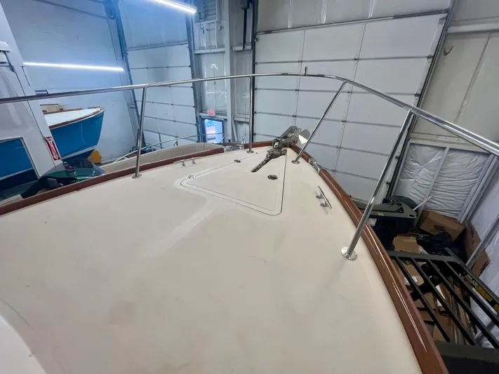  Yacht Photos Pics 2005 Hinckley Picnic Boat EP bow view in a storage facility.