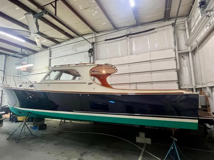  Yacht Photos Pics 2005 Hinckley Picnic Boat EP in a garage, showcasing elegant design and craftsmanship.