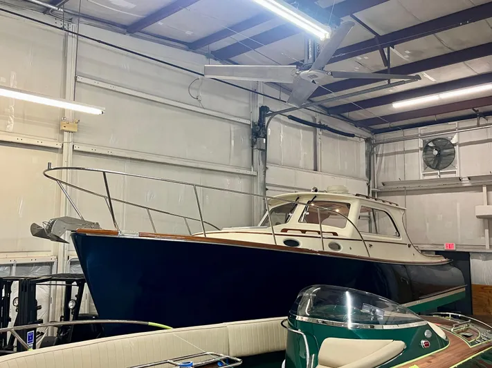  Yacht Photos Pics 2005 Hinckley Picnic Boat EP in a storage facility, showcasing classic design and craftsmanship.