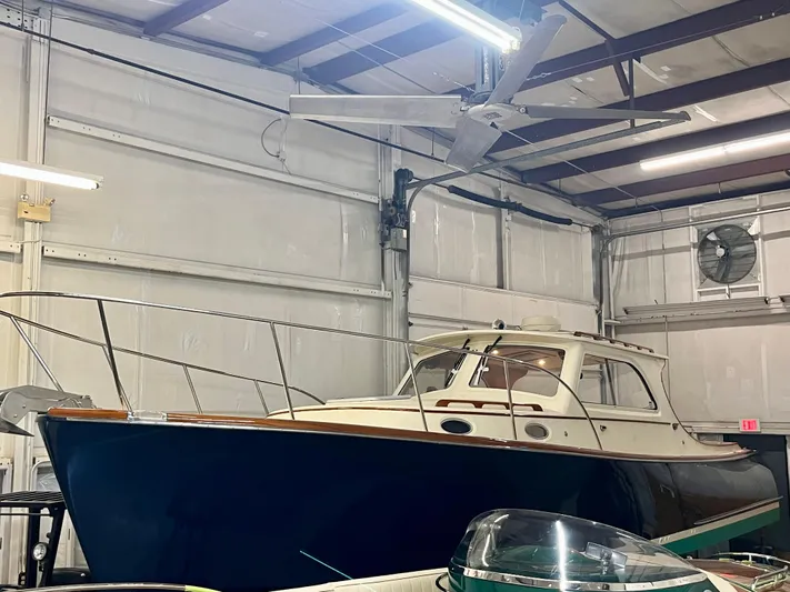  Yacht Photos Pics 2005 Hinckley Picnic Boat EP in a warehouse, showcasing classic design and elegant craftsmanship.