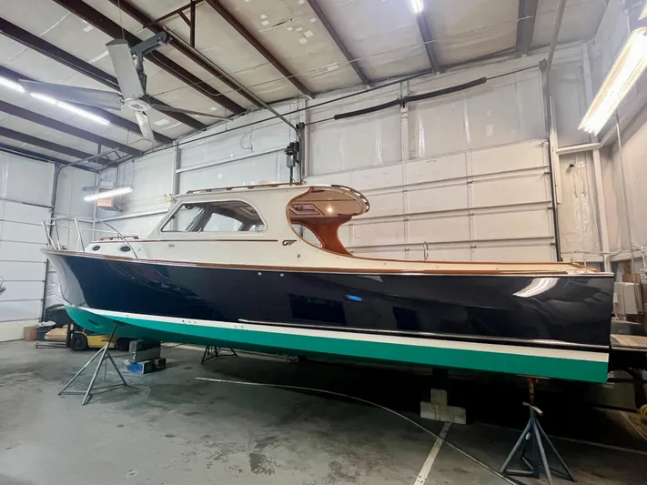  Yacht Photos Pics 2005 Hinckley Picnic Boat EP in a garage, showcasing classic design and elegant craftsmanship.